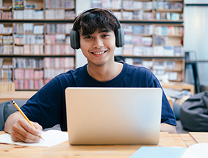 Student working on a laptop in a library